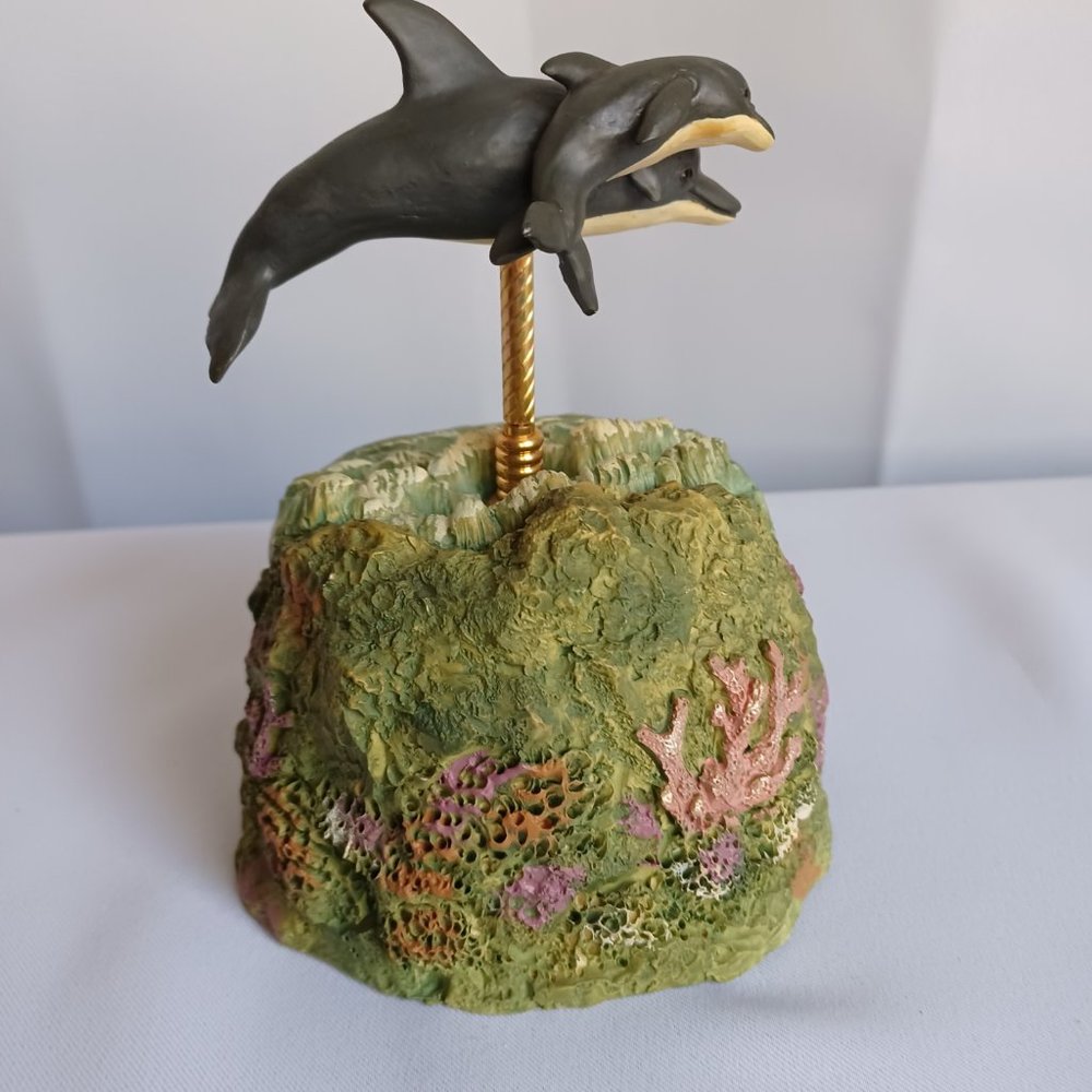 Musical moving  Dolphins figurines  on top of the ocean,Tune fascination